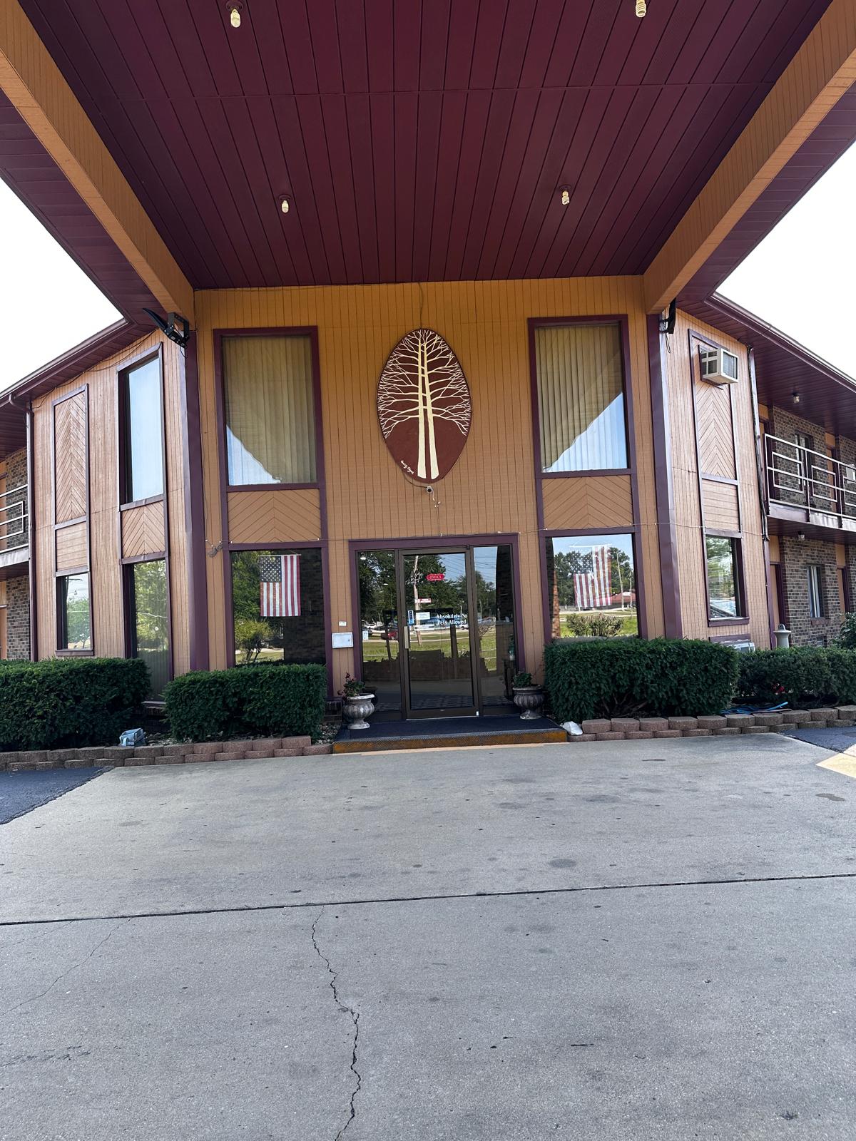 Exterior walkway with room entrances at dusk