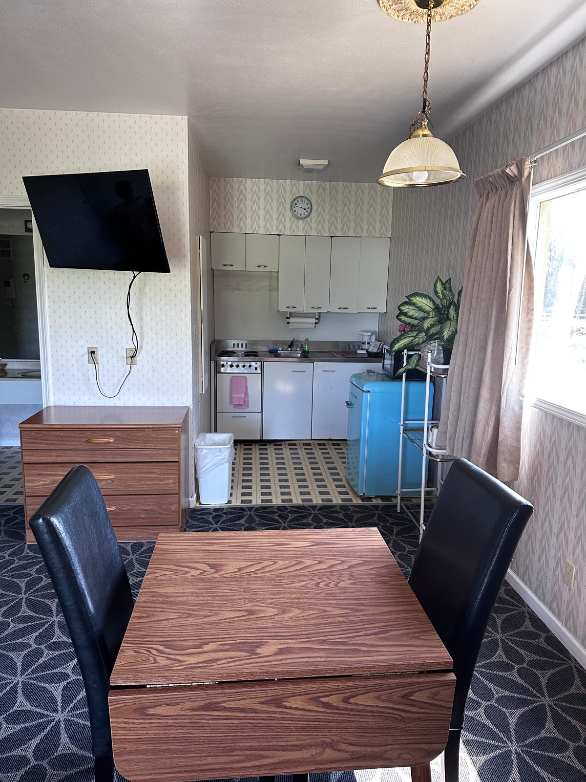 Bright guest room with two beds and accent wall